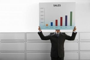 Businessman Holding Graph